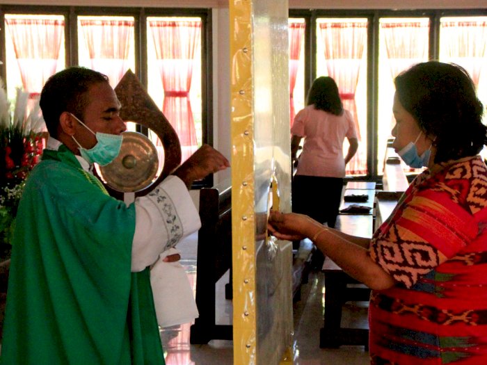 FOTO: Umat Katolik Mulai Beribadah Kembali di Gereja 
