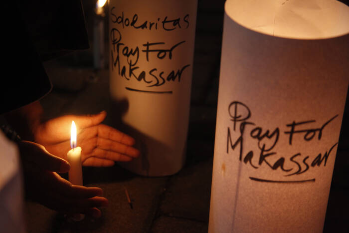 ANTARA FOTO/Maulana Surya Warga menyalakan lilin untuk para korban ledakan bom di Makasar