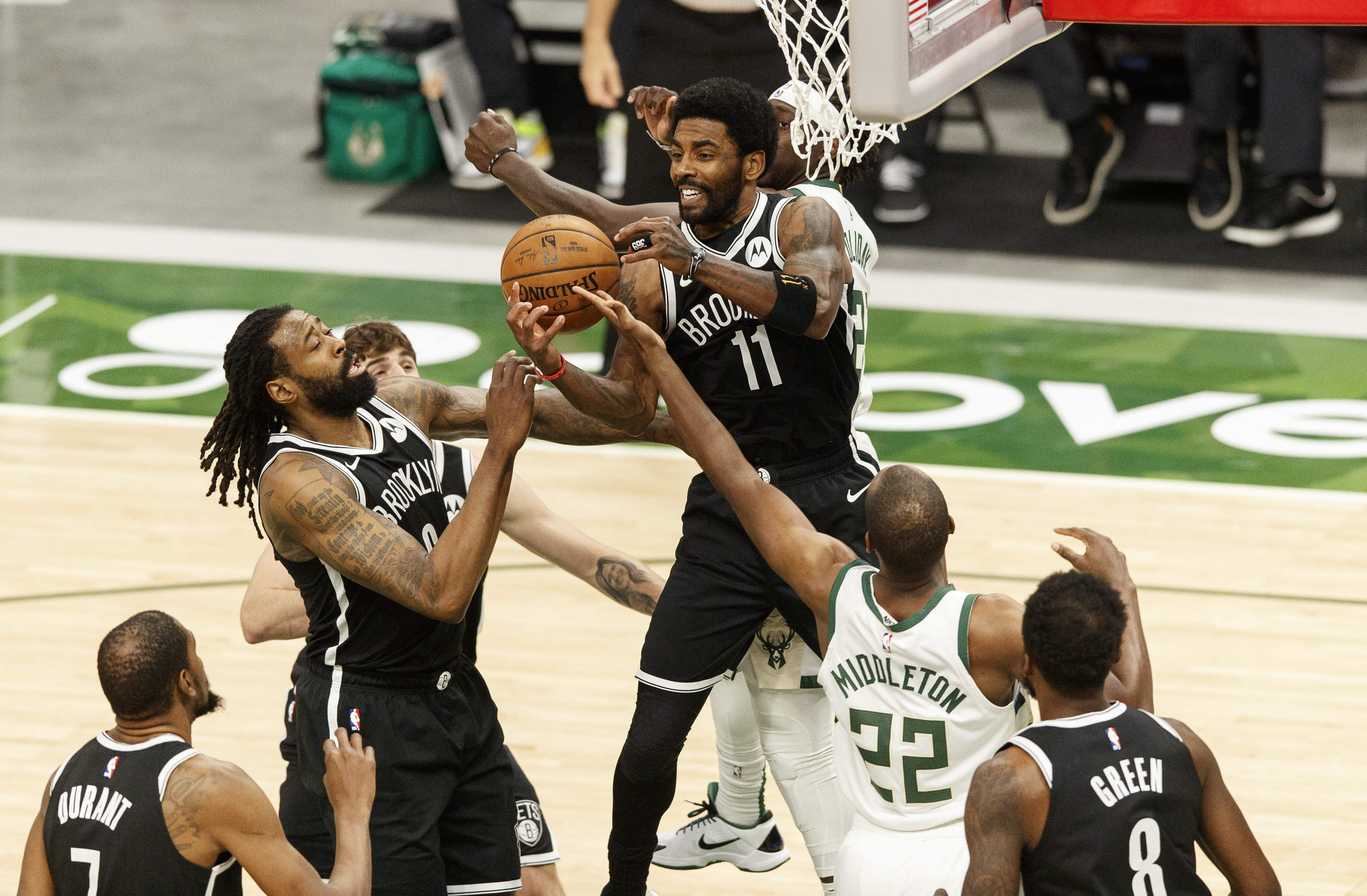 Center Brooklyn Nets DeAndre Jordan (6), guard Kyrie Irving (11) dan penyerang Milwaukee Bucks Khris Middleton (22) melakukan rebound (REUTERS/Jeff Hanisch) Center Brooklyn Nets DeAndre Jordan (6), guard Kyrie Irving (11) dan penyerang Milwaukee Bucks Khris Middleton (22) melakukan rebound